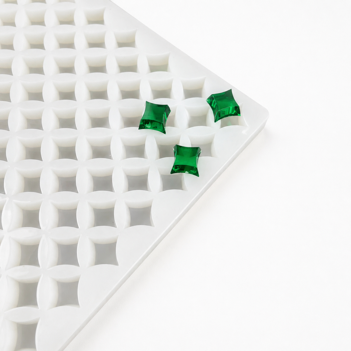 Square silicone gummy mold with emerald-green gummies for bulk made-to-order production