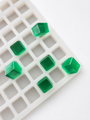 Close-up of the 2.85mL 315-cavity cube gummy mold showing emerald green cube gummies and cavity depth