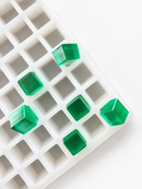 2.85mL cube gummy mold with 315 cavities and emerald green gummy samples on a white background