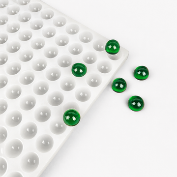 2.8mL half-sphere silicone gummy mold with translucent emerald green gummy samples