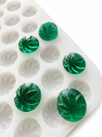 3.1mL leaf gummy mold with 185 cavities and emerald green leaf gummies on a white background