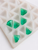 Detailed view of a 3.5mL diamond gummy mold with 173 cavities and glossy emerald green diamond gummies