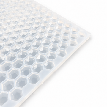 Close-up of a 3mL hexagon gem gummy mold with 263 cavities on a white background